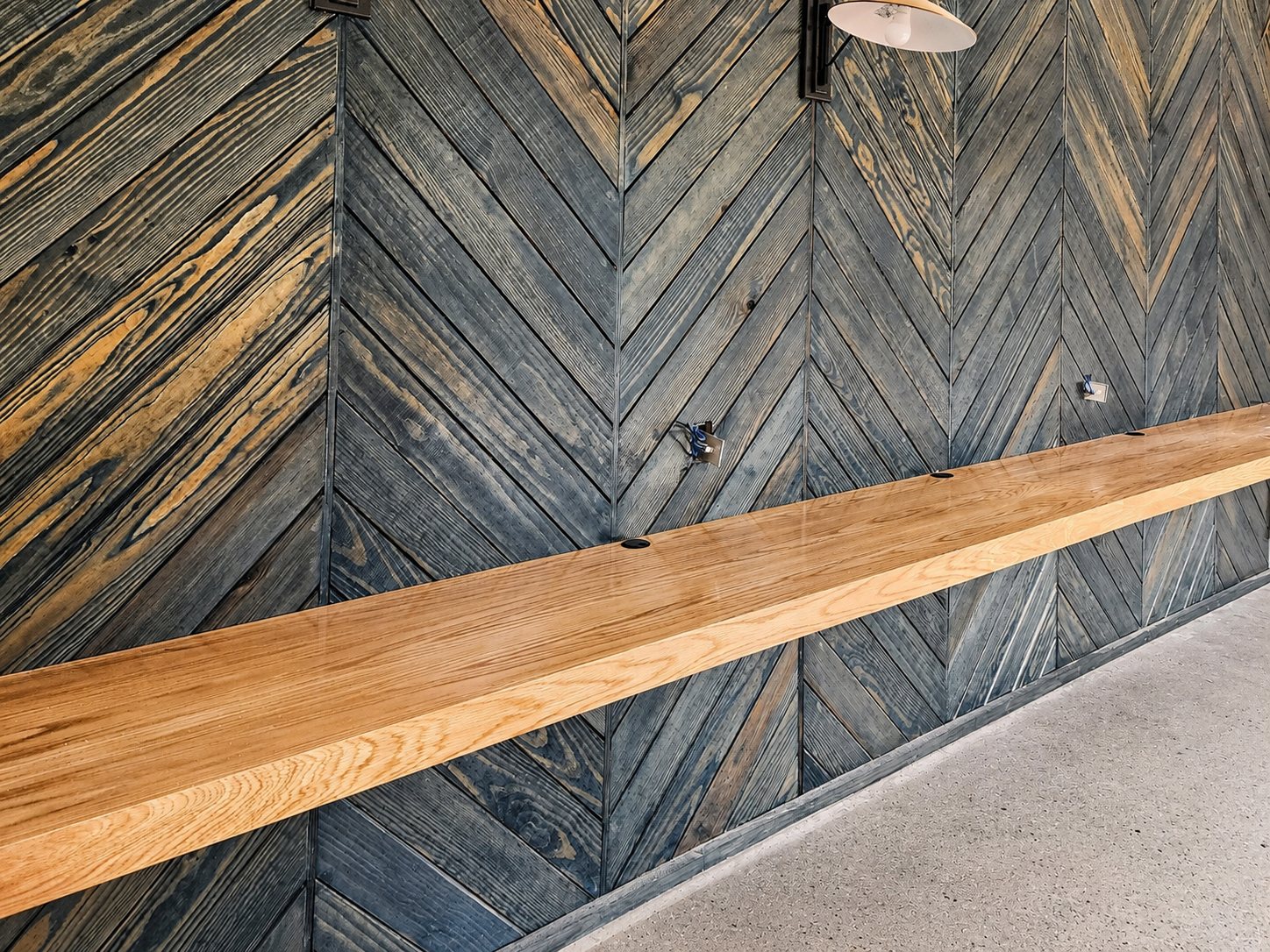 Chevron reclaimed wood wall with live-edge bar