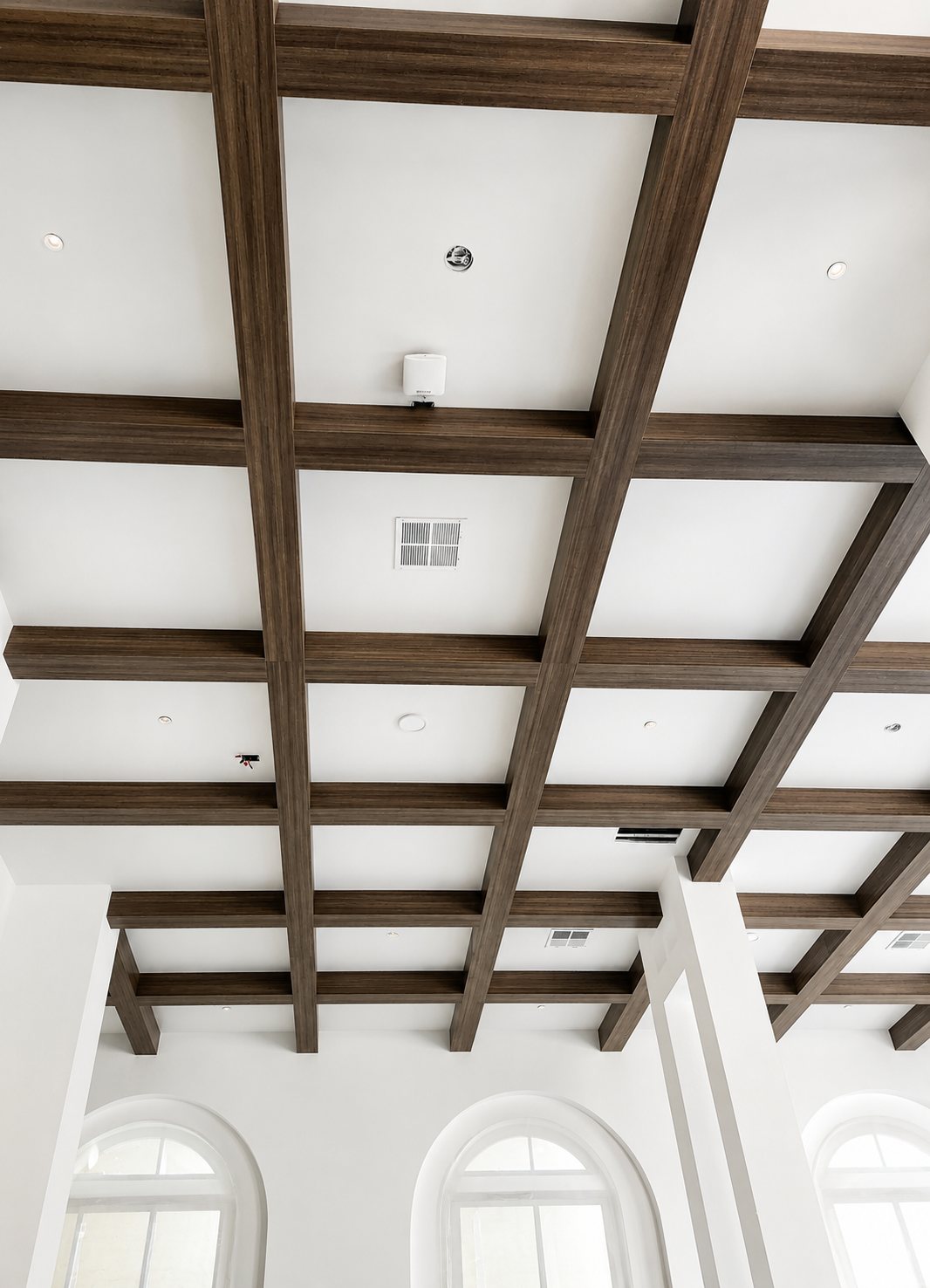 Coffered wood beam ceiling with arched windows